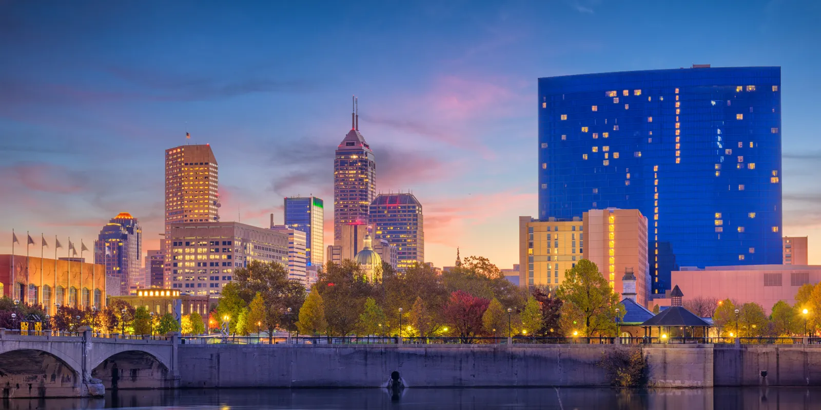 The Indianapolis skyline at dusk reflected in the White River.